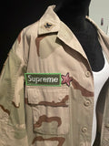 LONG SUPREME CAMO JACKET WITH PATCHED DESIGNS